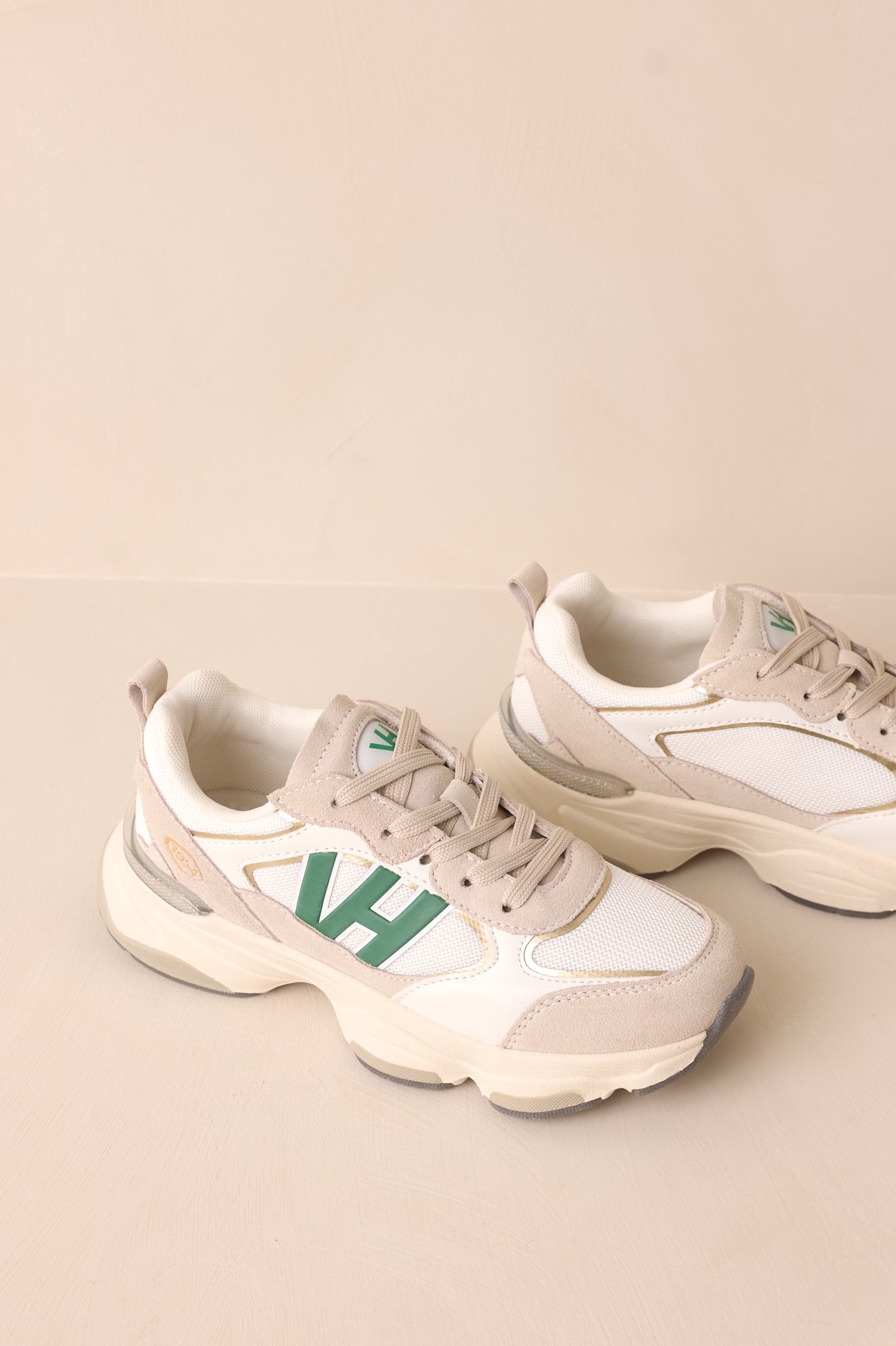 The sneakers’ thick beige sole stands out with subtle grey accents on the bottom, adding a sporty touch