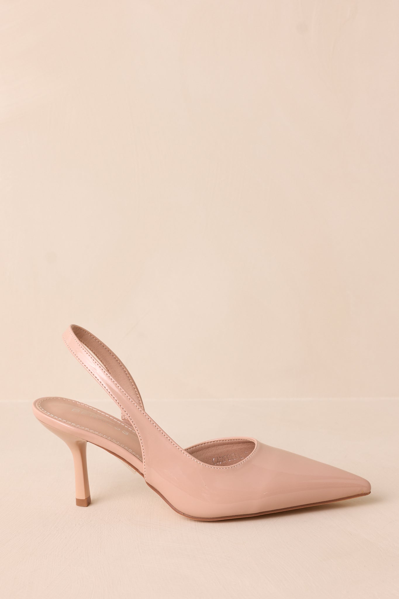 The slingback ankle strap and cushioned sole provide both style and comfort in these chic heels.