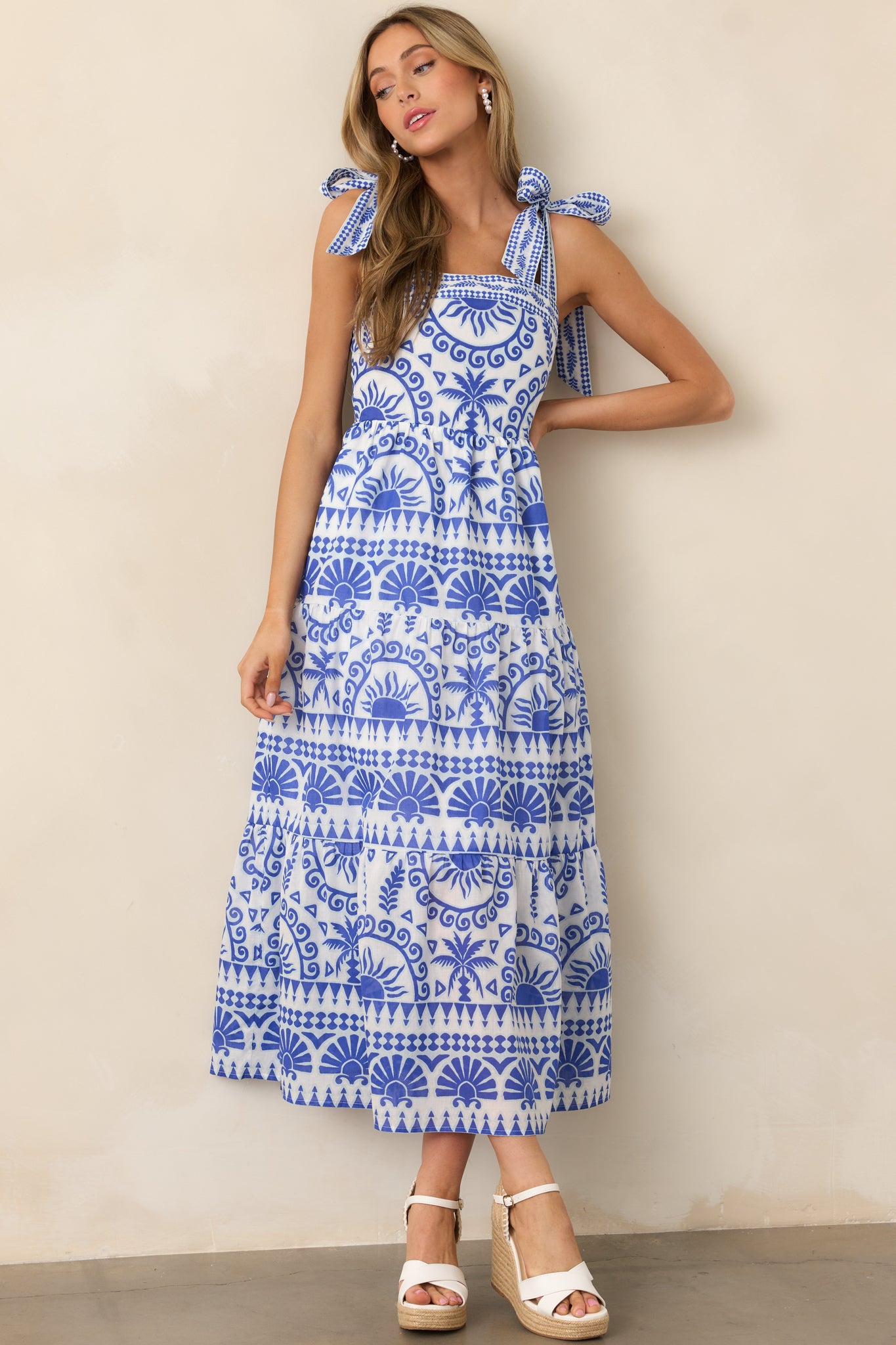 A tropical-print maxi dress with a straight neckline, shown in full length from the front, emphasizing its vibrant pattern and flowing silhouette.