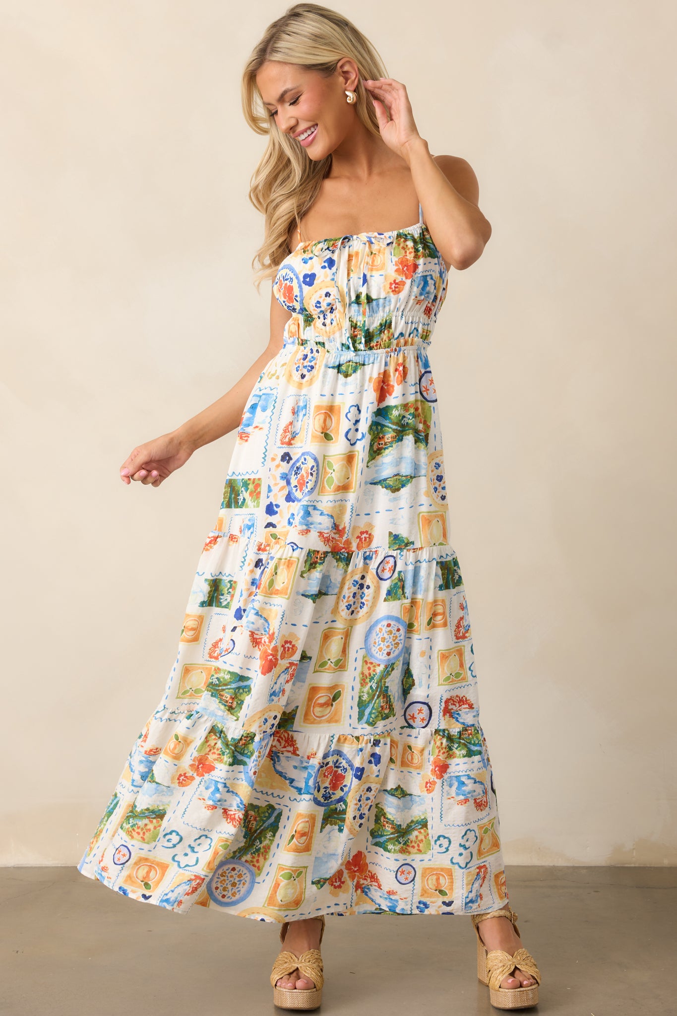 Watercolor print maxi dress featuring adjustable spaghetti straps, an open back, and a flattering elastic waistband.