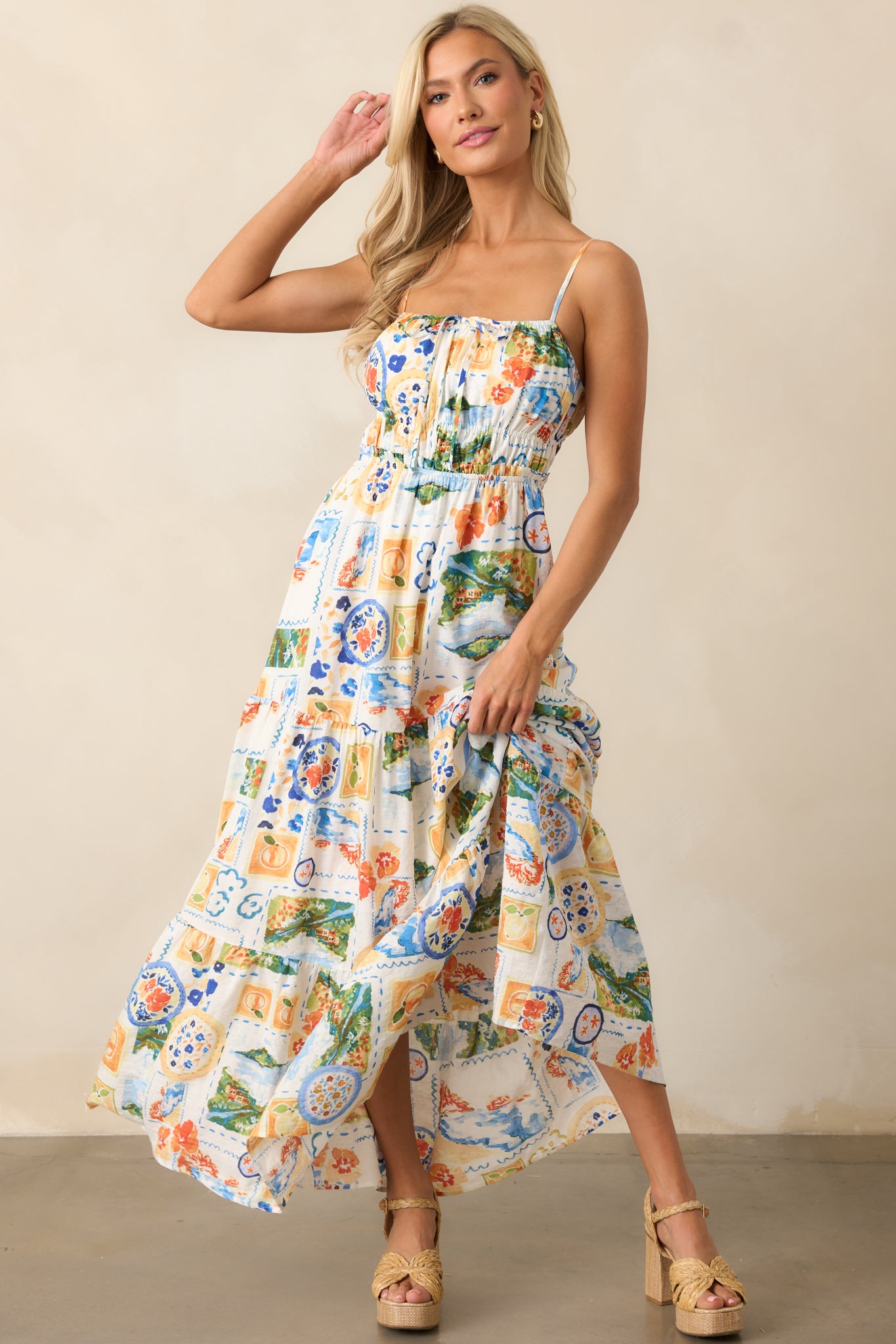 Flowing maxi dress with a straight cinch neckline, elastic waistband, and tiered skirt design, perfect for a relaxed, elegant look.