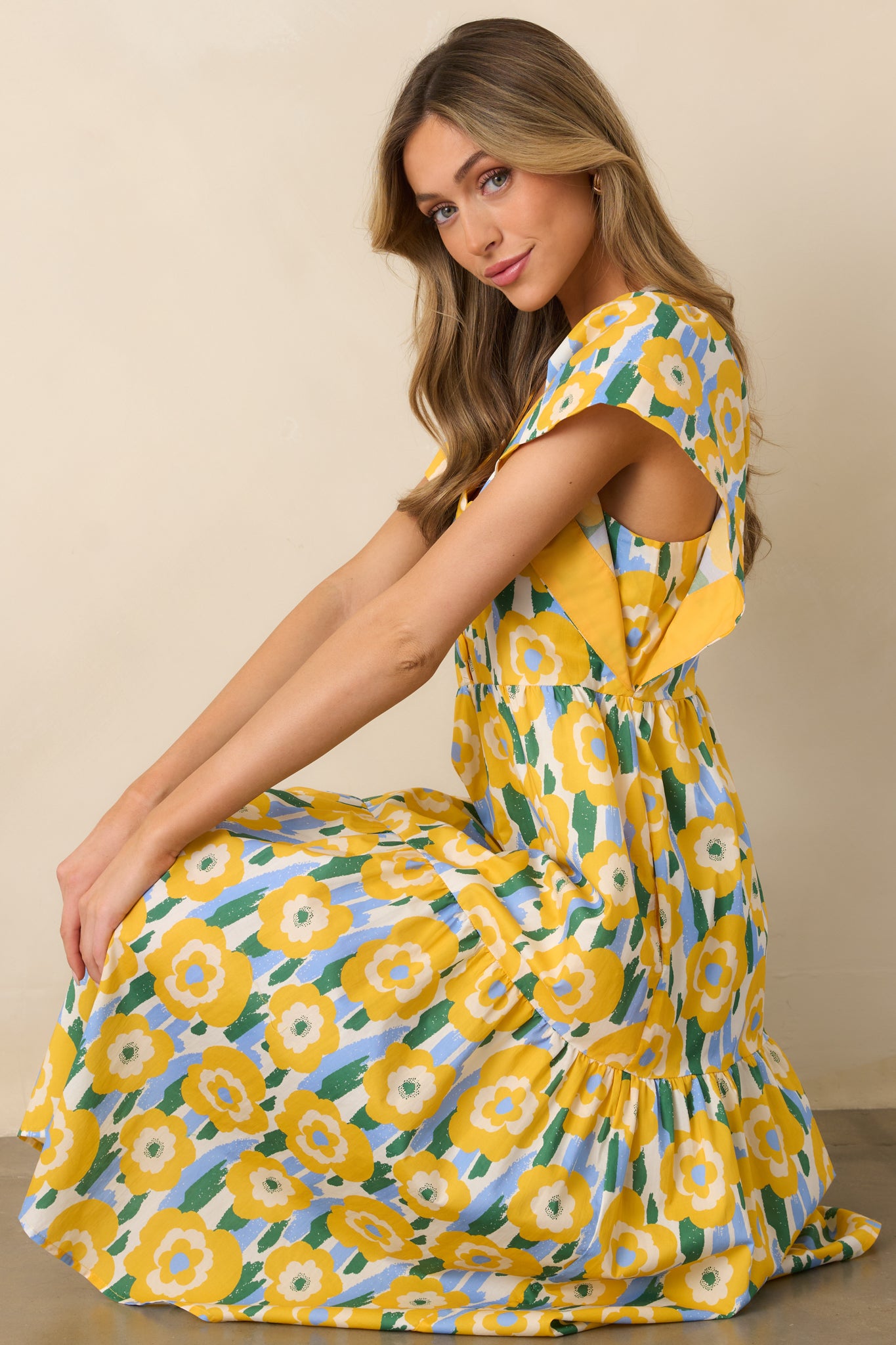 Bright yellow dress with a V-neckline and three functional buttons, creating a classic, stylish silhouette.