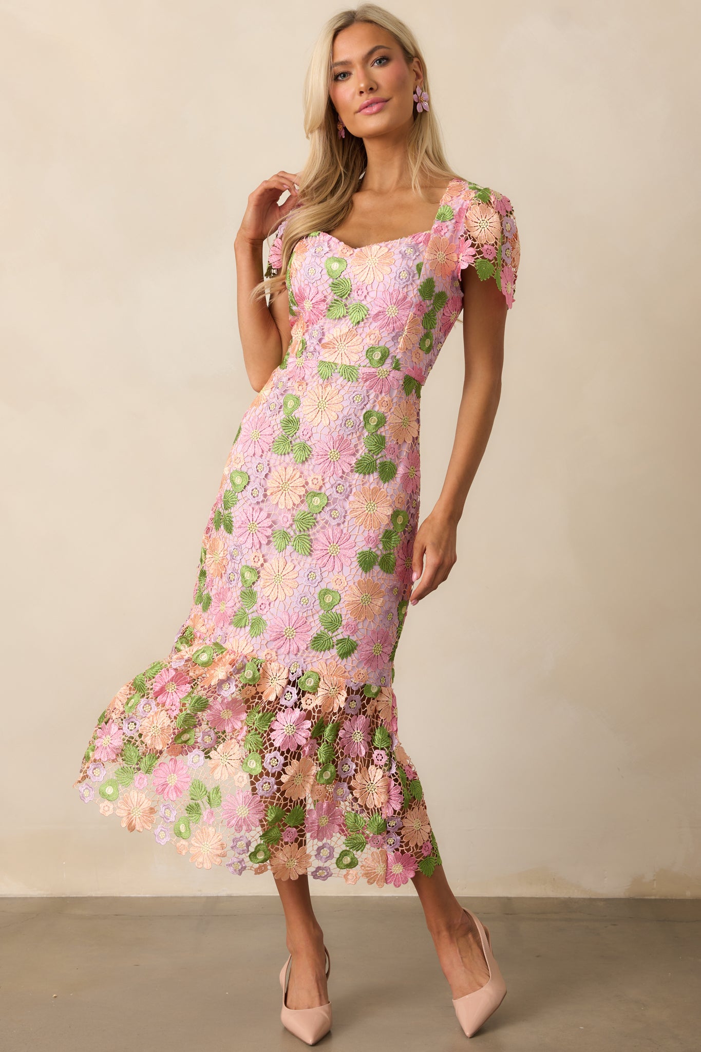 The dress showcases intricate floral embroidery throughout, enhancing its fitted and elegant design.