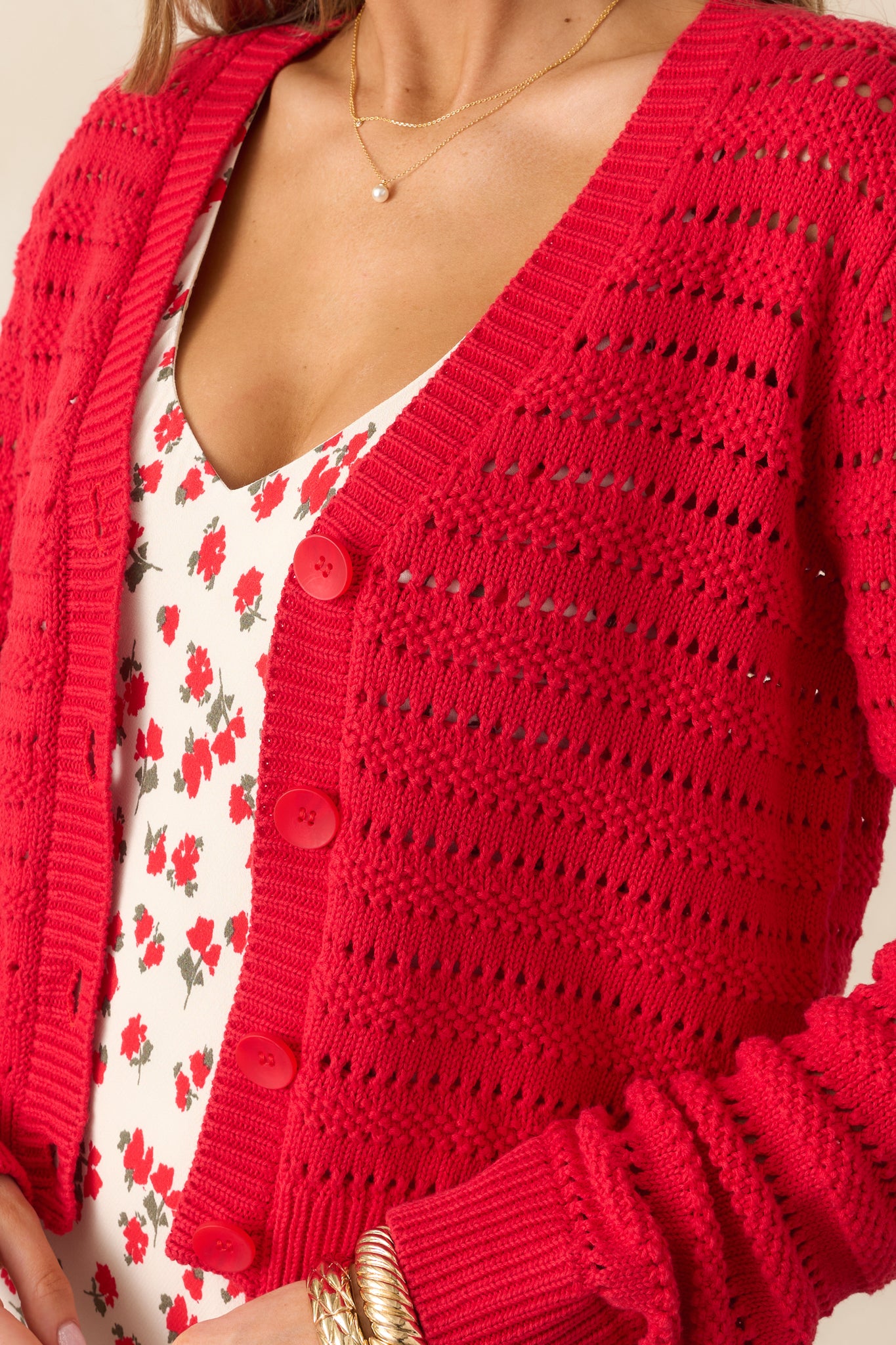 A detailed shot highlighting the open stitch pattern on the body of the cardigan, with close-up focus on the fabric texture and ribbed stitching.