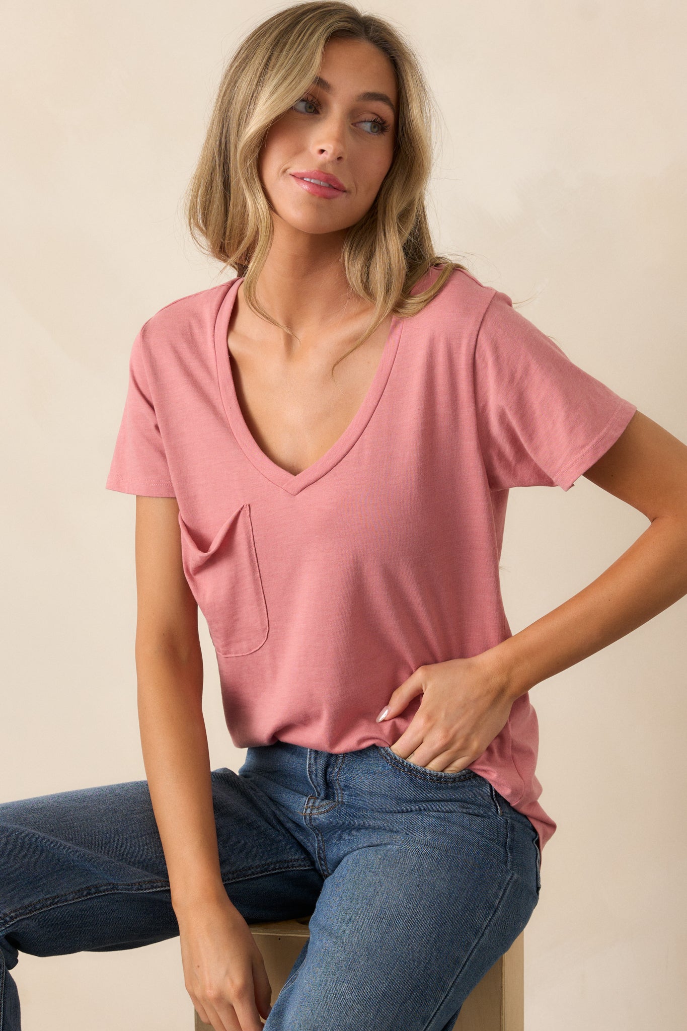 Front view of a rosebud tee featuring a v-neckline, a functional chest pocket, a super soft fabric, and a scooped hemline.