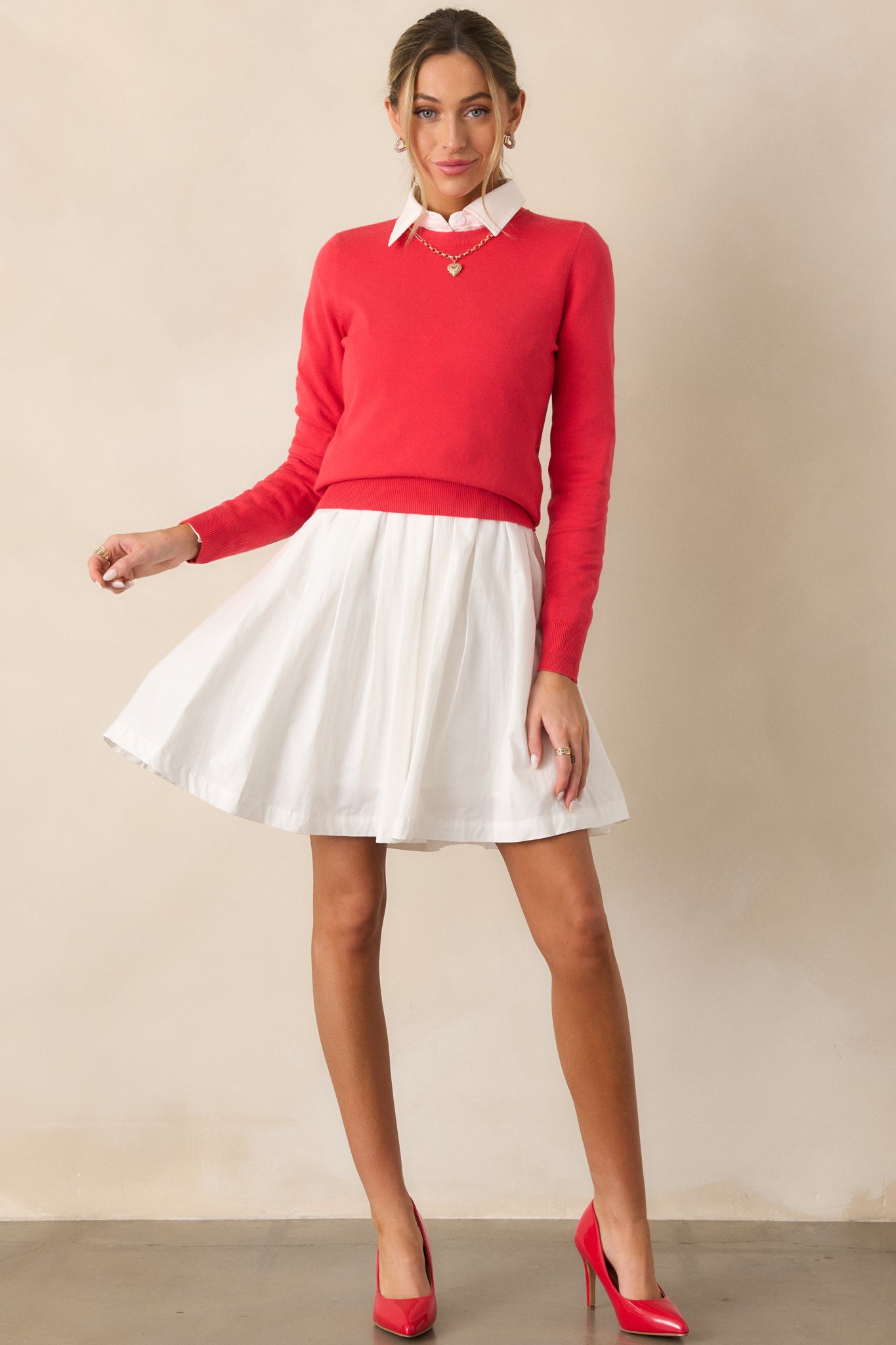 A full view of the red sweater showcasing its rounded crew neckline, relaxed fit, long sleeves, and rib-knit hems, giving it a cozy and casual look.