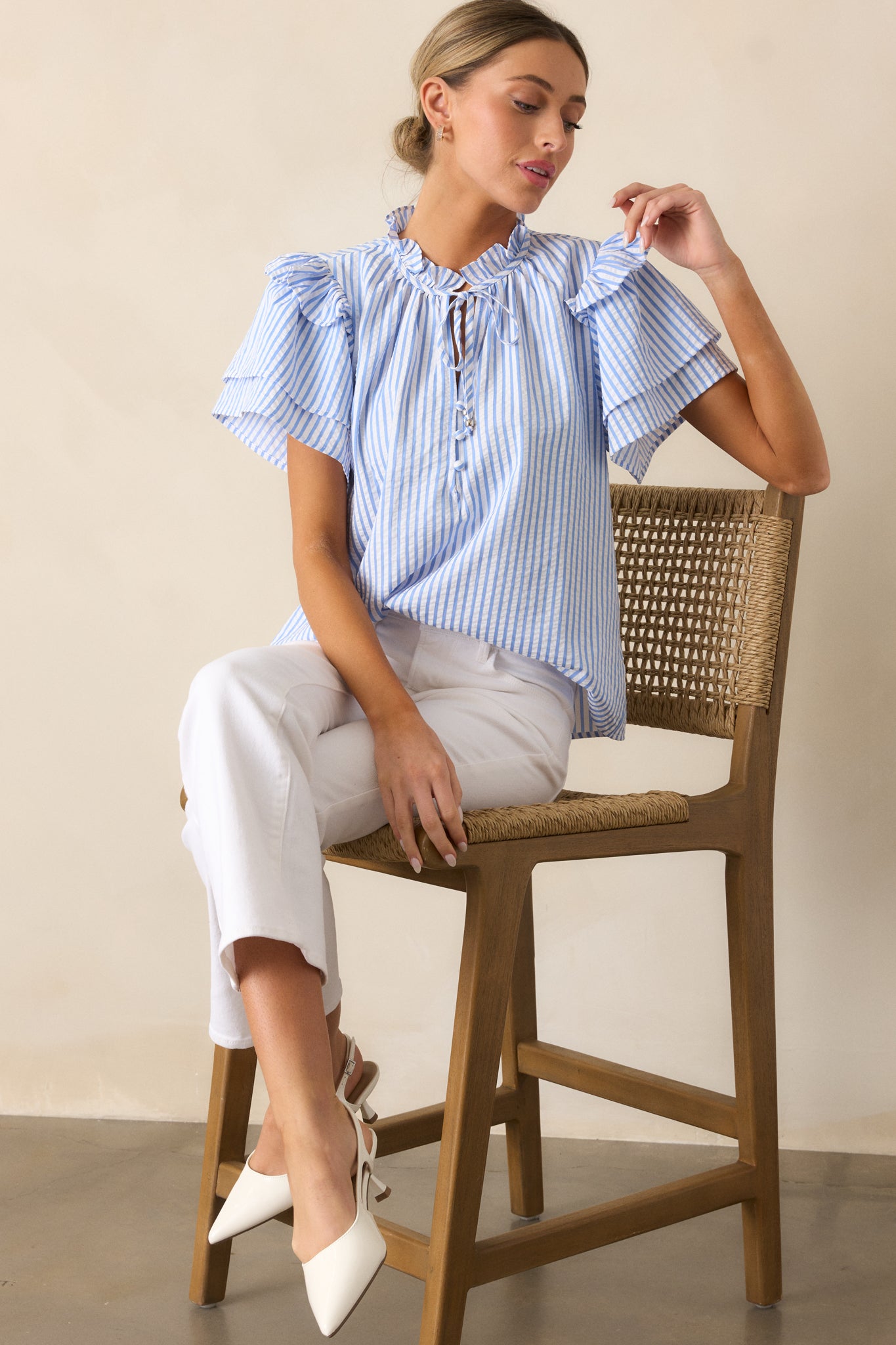 Full view of a Blue Stripe Blouse featuring a ruffle-trimmed high collar, self-tie keyhole, double-tiered ruffle sleeves, and a vertical blue and white stripe pattern.