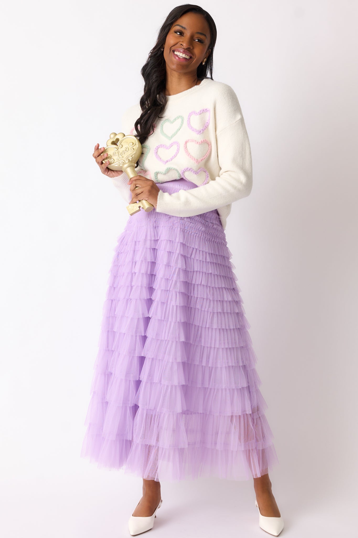 Full body view of a lavender skirt with an elastic waistband and a flowing, tiered tulle design reaching maxi length.