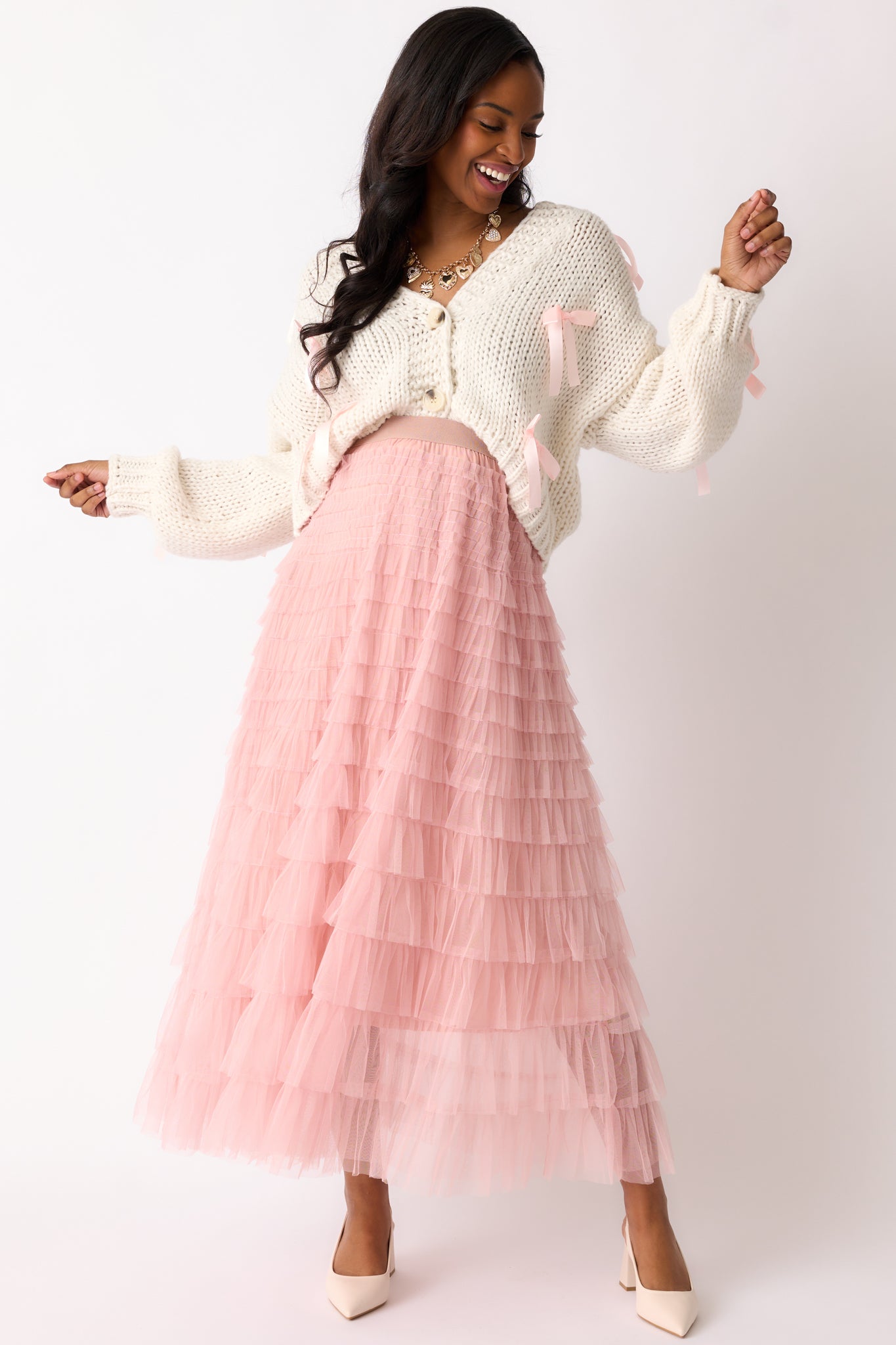 Full body view showcasing the dusty pink skirt’s maxi length and tiered layers of tulle for a soft, voluminous look.