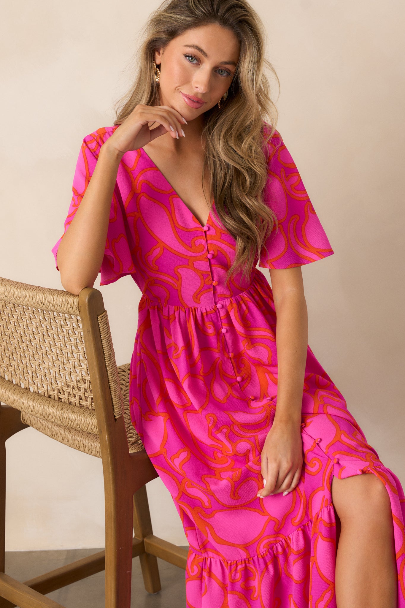 A relaxed view of the magenta maxi dress, with its tiered skirt gently draped and flowy short sleeves adding to the graceful silhouette.