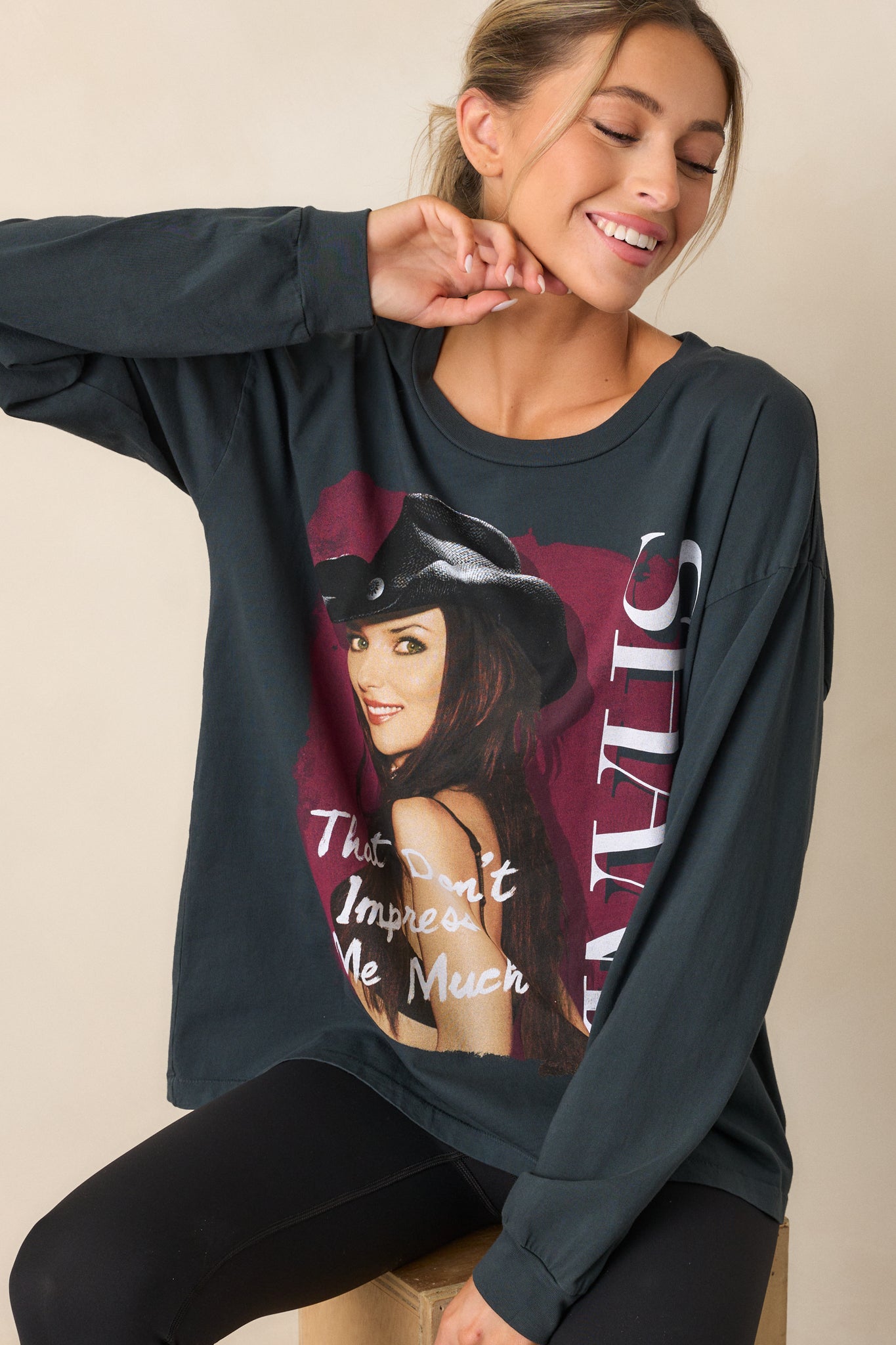 Cropped view focusing on the rounded crew neckline and part of the Shania Twain photo graphic on the vintage black tee.