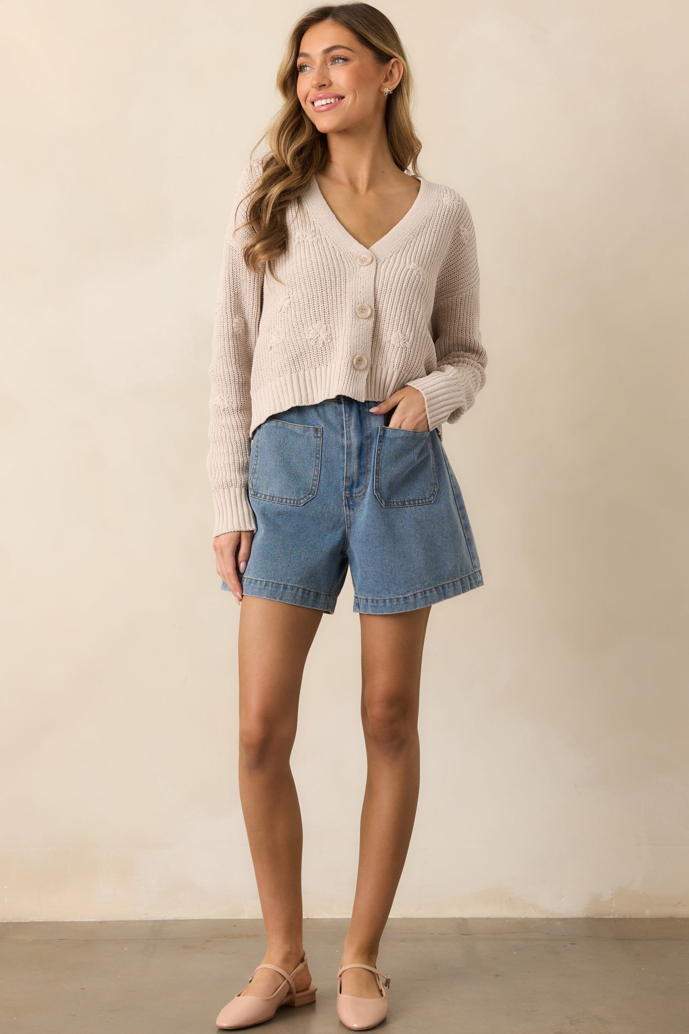 Denim shorts featuring a high-rise design and a paper bag stretchy waistband for a comfortable fit.